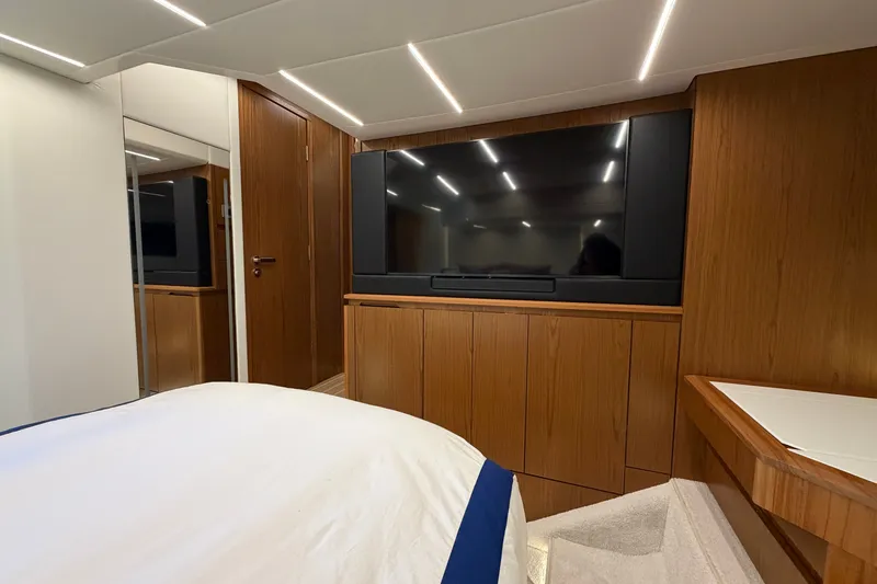 Slide: The Image of Luxurious interior of 2026 Tiara Yachts EX 54 with wood paneling and modern TV setup. - 23