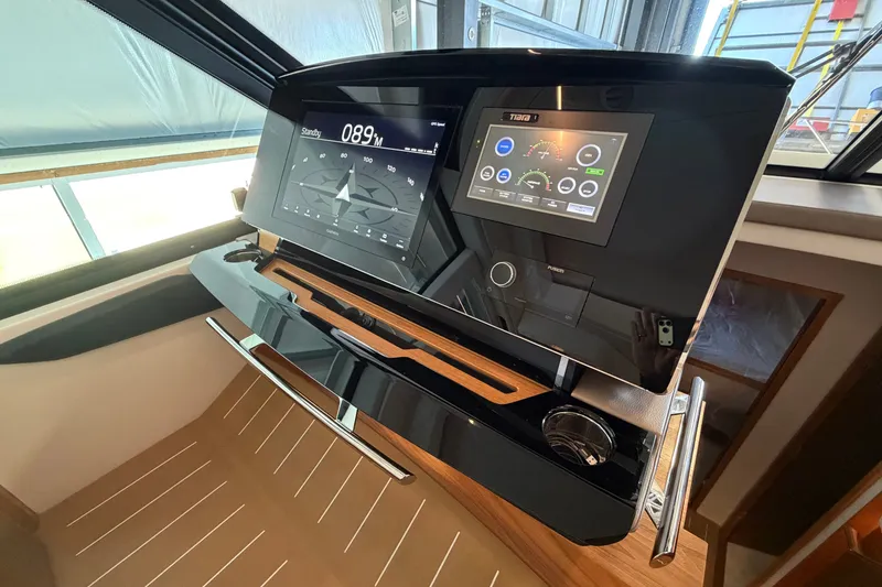 Slide: The Image of Helm of 2026 Tiara Yachts EX 54 featuring advanced navigation displays and controls. - 9