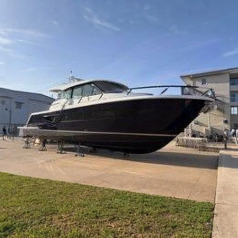 Slide: The Image of The 2026 Tiara Yachts EX 54 is on a dry dock, surrounded by buildings. - 1