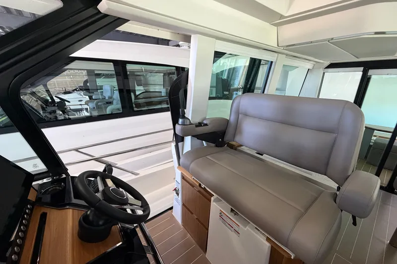Slide: The Image of Interior view of 2026 Tiara Yachts EX 54 helm with modern steering and seating. - 32