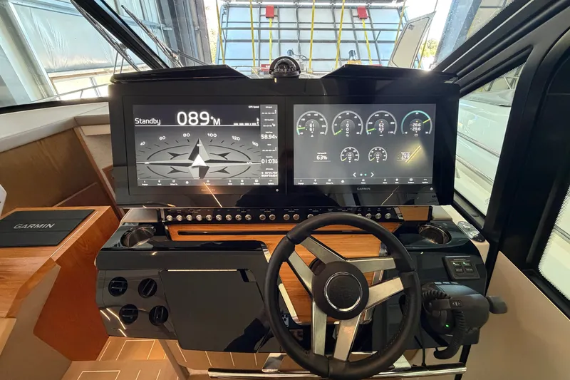 Slide: The Image of Helm of 2026 Tiara Yachts EX 54 with advanced navigation displays and controls. - 7