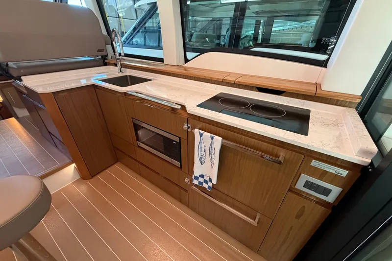 Slide: The Image of Modern kitchen in 2026 Tiara Yachts EX 54 with sleek countertops and appliances. - 27