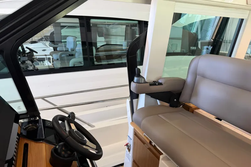 Slide: The Image of Interior view of 2026 Tiara Yachts EX 54 helm with steering wheel and seating. - 33