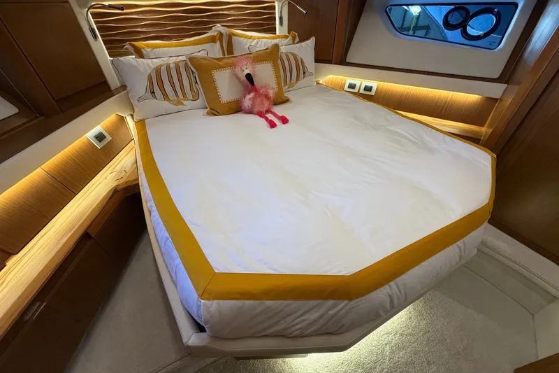 Slide: The Image of Luxurious bedroom interior of 2026 Tiara Yachts EX 54 with plush bedding and elegant lighting. - 12