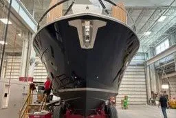 Slide: The Image of 2026 Tiara Yachts EX 54 in a shipyard, showcasing sleek design and craftsmanship. - 2