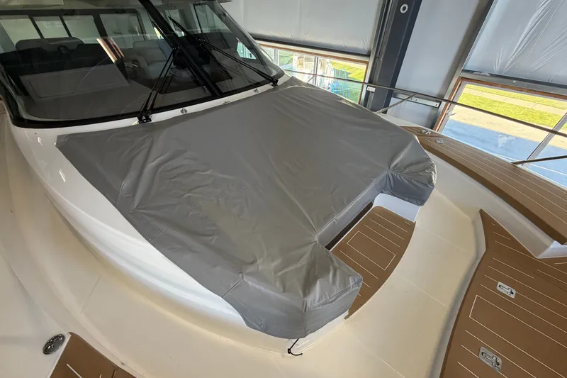 Slide: The Image of 2026 Tiara Yachts EX 54 with covered deck in a showroom. - 41