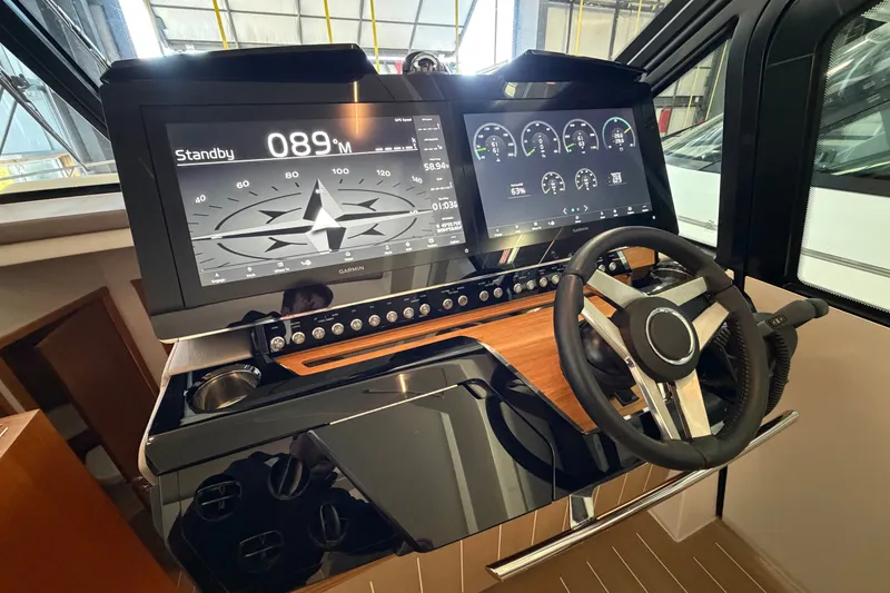 Slide: The Image of Helm of 2026 Tiara Yachts EX 54 featuring advanced navigation displays and controls. - 6