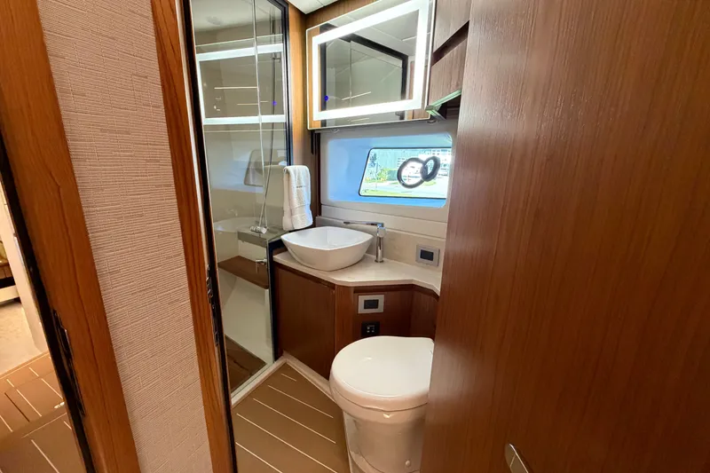 Slide: The Image of Luxurious bathroom in 2026 Tiara Yachts EX 54, featuring modern fixtures and elegant wood finishes. - 14