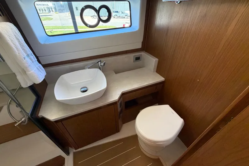 Slide: The Image of Luxurious bathroom in 2026 Tiara Yachts EX 54, featuring modern sink and toilet. - 25