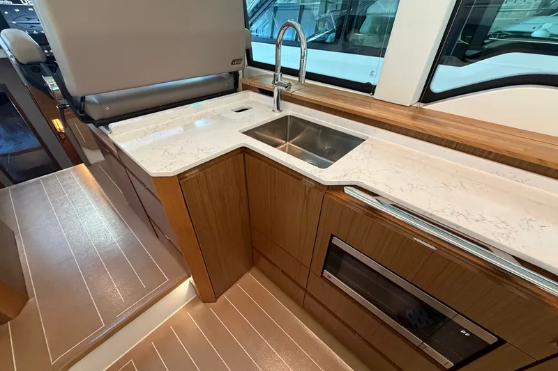 Slide: The Image of Luxurious 2026 Tiara Yachts EX 54 interior kitchen with sleek countertops and modern appliances. - 28