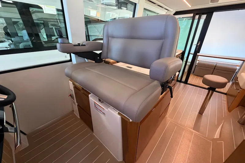 Slide: The Image of Captain's chair in 2026 Tiara Yachts EX 54, featuring luxurious interior design. - 8
