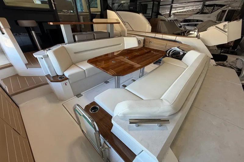 Slide: The Image of Luxurious seating area on 2026 Tiara Yachts EX 54 with elegant wooden table. - 37