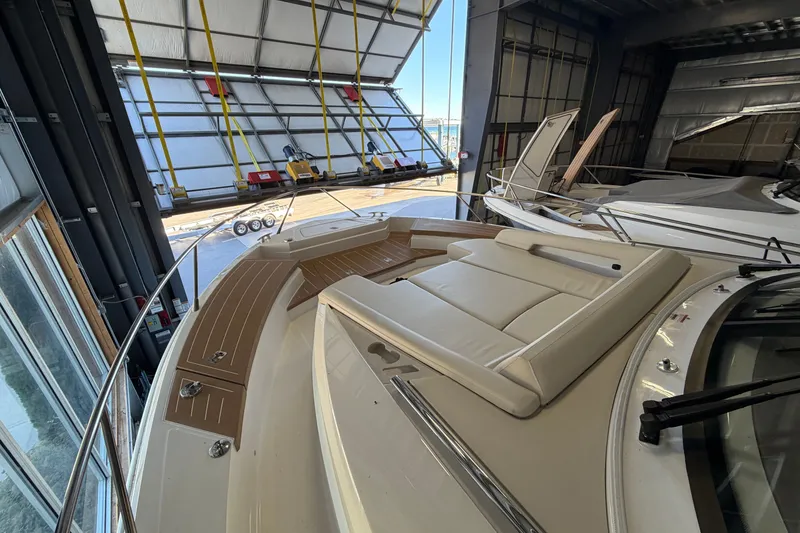 Slide: The Image of 2026 Tiara Yachts EX 54 in storage, featuring sleek deck and luxurious seating. - 31