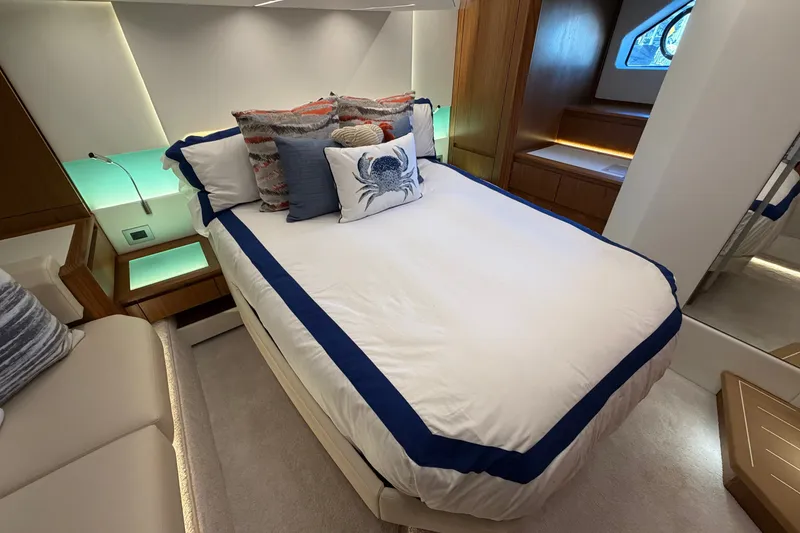 Slide: The Image of Luxurious bedroom interior of 2026 Tiara Yachts EX 54 with elegant bedding and ambient lighting. - 22
