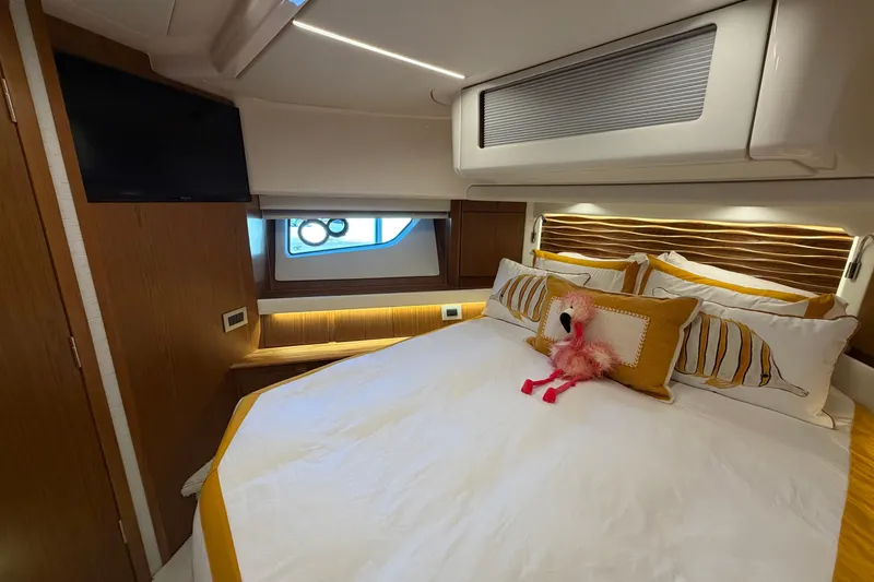 Slide: The Image of Luxurious cabin interior of 2026 Tiara Yachts EX 54, featuring elegant bedding and modern amenities. - 13