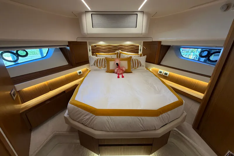 Slide: The Image of Luxurious bedroom interior of 2026 Tiara Yachts EX 54 with elegant bedding and ambient lighting. - 11