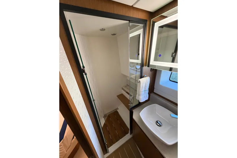 Slide: The Image of Luxurious bathroom in 2026 Tiara Yachts EX 54, featuring modern fixtures and elegant design. - 26