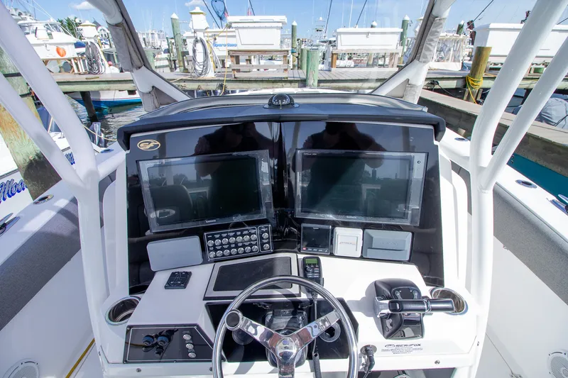Slide: The Image of The image shows the helm of a 2019 Sea Fox 328 Commander with modern instruments. - 25
