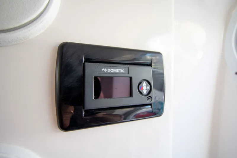 Slide: The Image of A Dometic control panel is mounted on a boat's wall. - 17