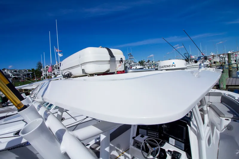 Slide: The Image of A 2019 Sea Fox 328 Commander with a modern helm and fishing rod holders at the dock. - 47