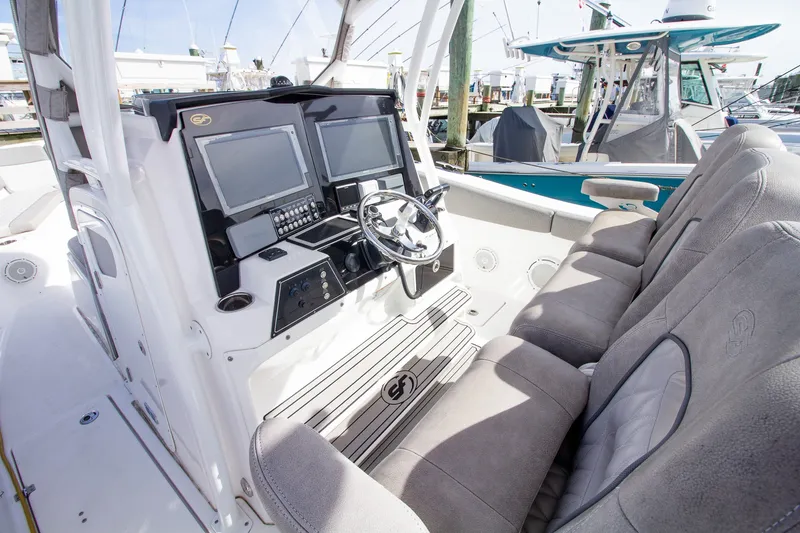 Slide: The Image of The image shows the cockpit of a 2019 Sea Fox 328 Commander with gray seats and modern electronics. - 19