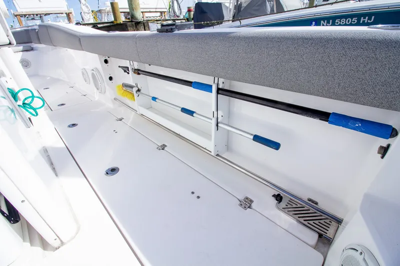 Slide: The Image of The image shows the deck of a 2019 Sea Fox 328 Commander with fishing rod holders. - 48