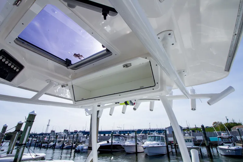 Slide: The Image of View from a boat with an open skylight, overlooking a marina with several boats. - 28
