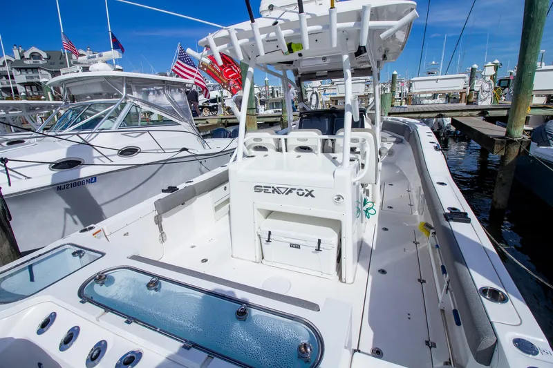 Slide: The Image of The image shows a 2019 Sea Fox 328 Commander boat docked at a marina. - 46