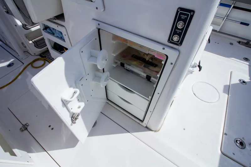 Slide: The Image of Open storage compartment with drawers and fishing gear on a boat. - 35