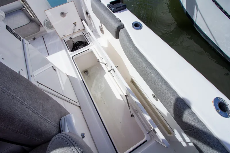 Slide: The Image of The image shows the seating area of a Sea Fox 328 Commander with open storage compartments. - 34