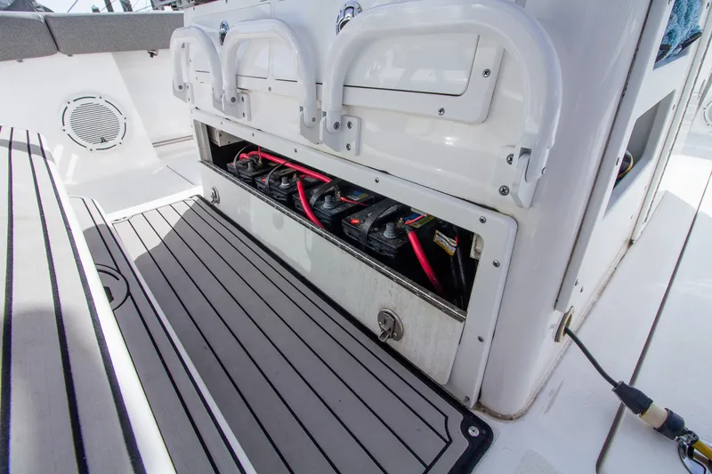 Slide: The Image of Battery compartment on a 2019 Sea Fox 328 Commander boat, featuring multiple batteries and cables. - 26