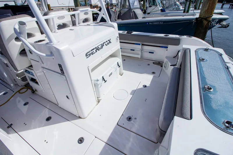 Slide: The Image of The image shows the cockpit of a 2019 Sea Fox 328 Commander with seating and storage. - 33