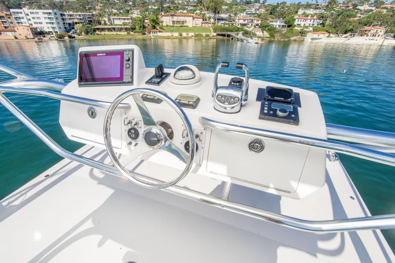 Slide: The Image of Helm of 2005 Cabo 35 Express boat with navigation equipment and scenic waterfront view. - 7