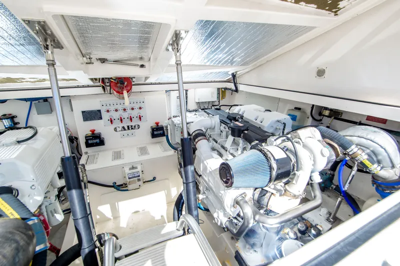 Slide: The Image of Engine room of a 2005 Cabo 35 Express boat, showcasing mechanical components. - 31