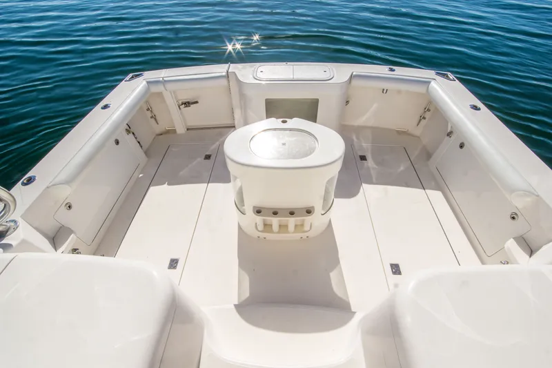 Slide: The Image of 2005 Cabo 35 Express boat deck with seating, surrounded by calm blue water. - 16
