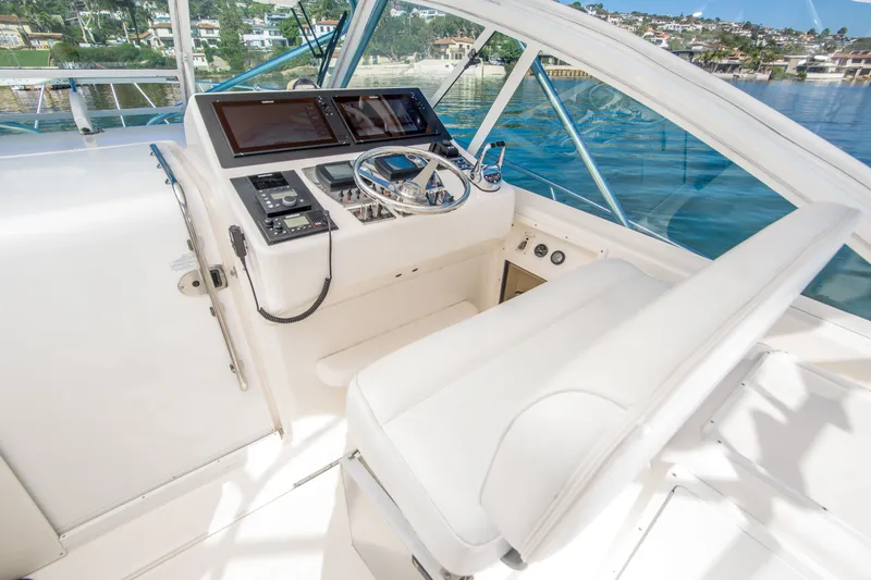 Slide: The Image of Helm of 2005 Cabo 35 Express boat with modern controls and panoramic view. - 11