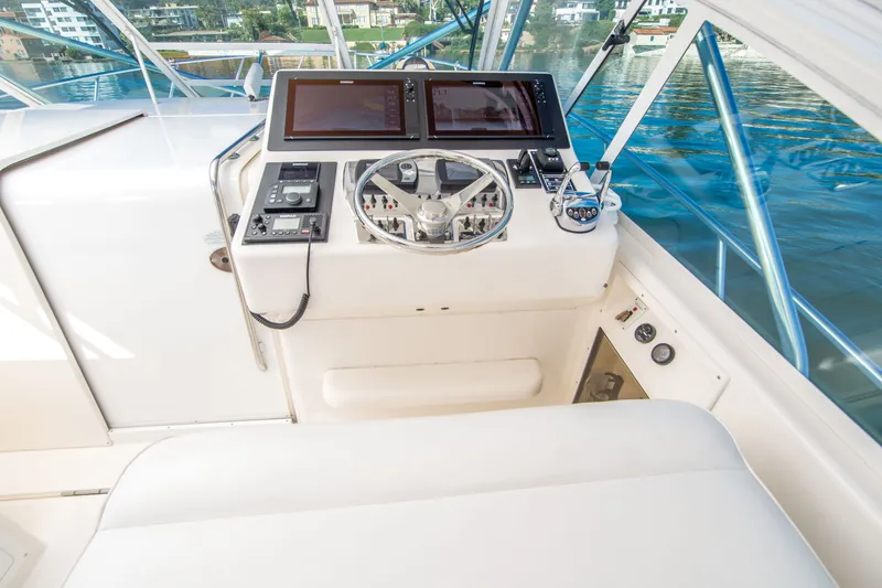 Slide: The Image of Helm of 2005 Cabo 35 Express boat with modern controls and dual screens. - 10