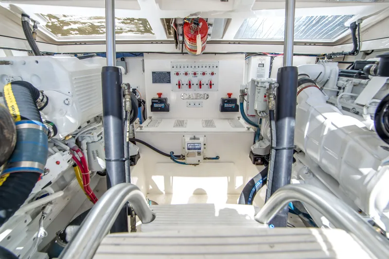 Slide: The Image of Engine room of a 2005 Cabo 35 Express boat, showcasing machinery and control panels. - 32
