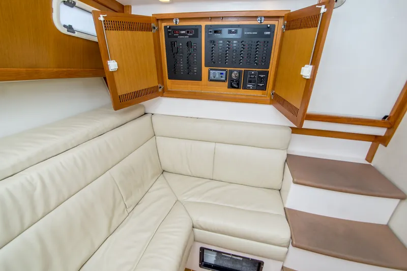 Slide: The Image of Interior of 2005 Cabo 35 Express yacht with beige seating and control panel. - 27