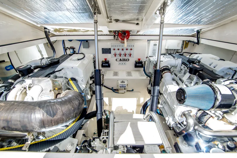 Slide: The Image of Engine room of a 2005 Cabo 35 Express boat, showcasing dual engines and control systems. - 30