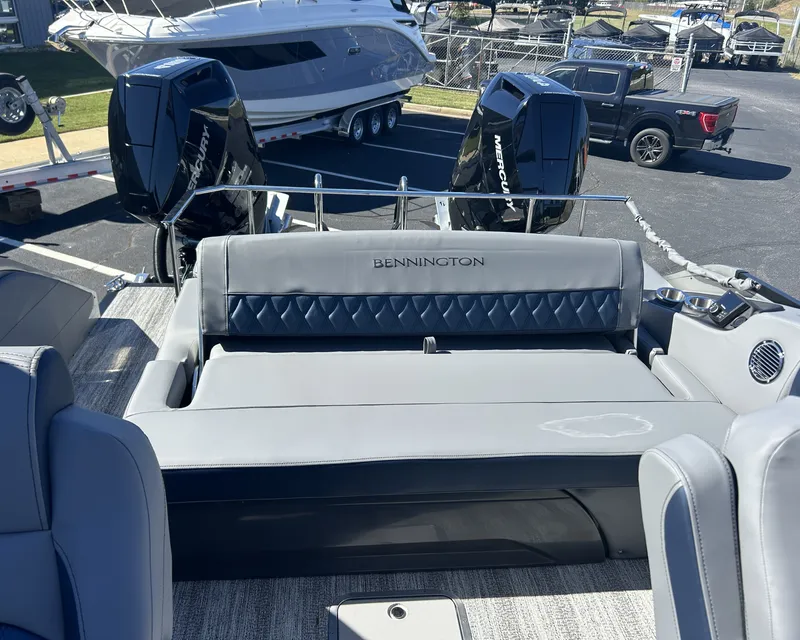 Slide: The Image of The image shows the stern of a Bennington 27QXSB boat with two outboard motors. - 14