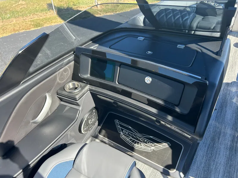 Slide: The Image of The image shows the cockpit of a 2027 Bennington 27QXSB with modern controls and sleek seating. - 22