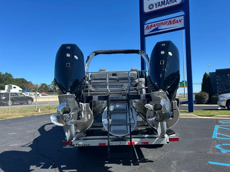 Slide: The Image of 2027 Bennington 27QXSB with dual outboard engines on a trailer. - 5