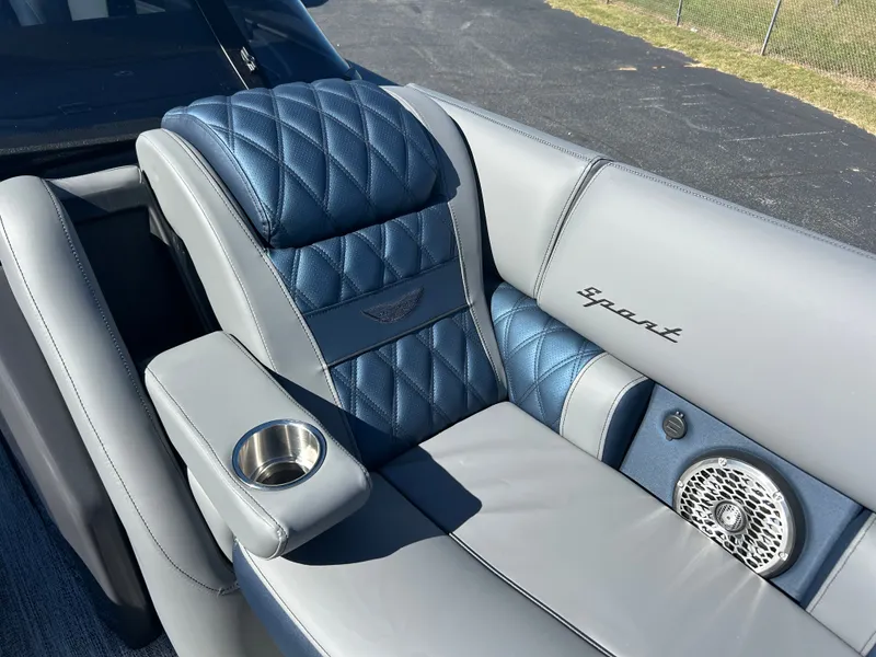 Slide: The Image of Luxurious gray and blue upholstery with a speaker and a cup holder. - 33