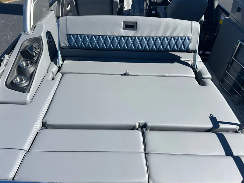 Slide: The Image of The image shows a luxurious gray boat seat with blue accents and cup holders. - 15