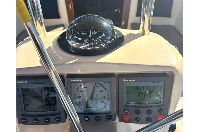 Slide: The Image of Island Packet 350 yacht dashboard with compass and Raytheon instruments, 2002 model. - 20
