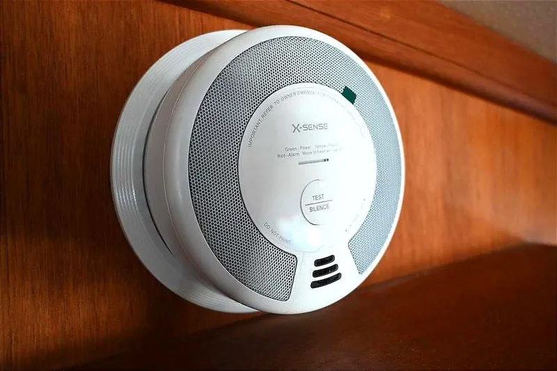Slide: The Image of Smoke detector installed on wooden panel of 2002 Island Packet 350 yacht. - 64