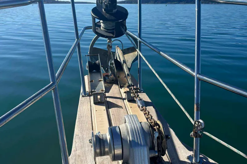 Slide: The Image of Bow of 2002 Island Packet 350 sailboat with anchor and calm water view. - 15