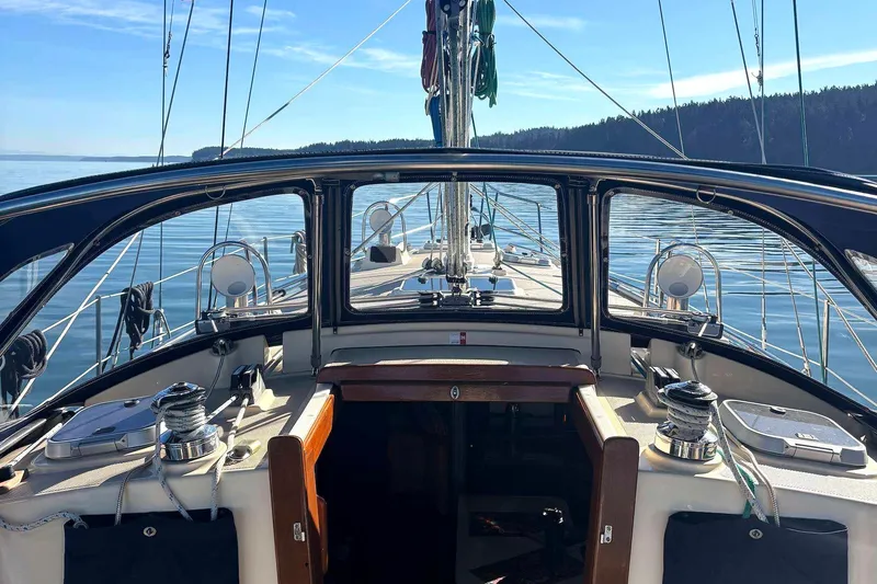 Slide: The Image of 2002 Island Packet 350 sailboat cockpit with ocean view and clear skies. - 8