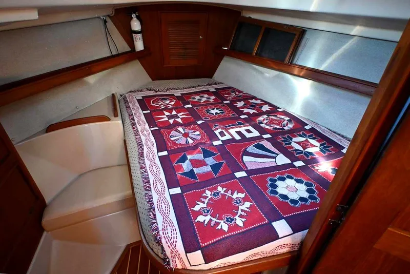 Slide: The Image of Cozy cabin interior of 2002 Island Packet 350 with patterned quilt on bed. - 39